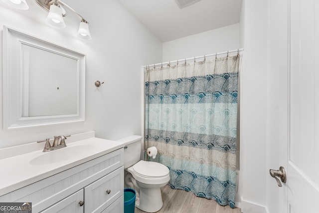 bathroom featuring vanity, toilet, and hardwood / wood-style floors