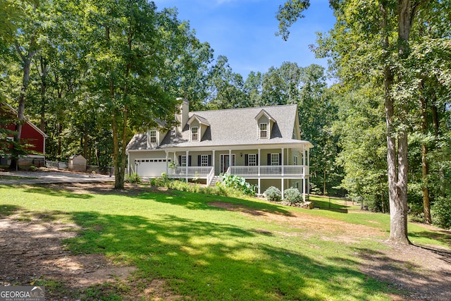 view of front of house with a garage, a porch, and a front yard