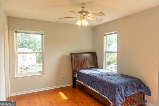 bedroom featuring ceiling fan and wood-type flooring