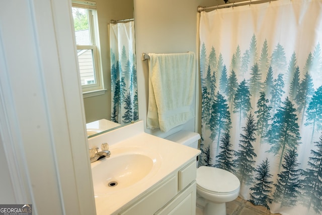 bathroom featuring vanity and toilet