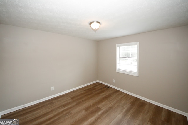 spare room with hardwood / wood-style floors