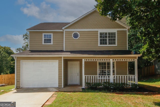 view of front of house featuring a garage, a front lawn, and covered porch