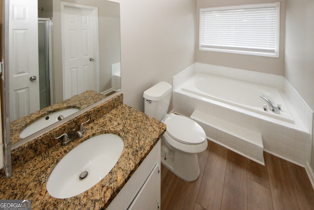 full bathroom featuring wood-type flooring, vanity, toilet, and shower with separate bathtub