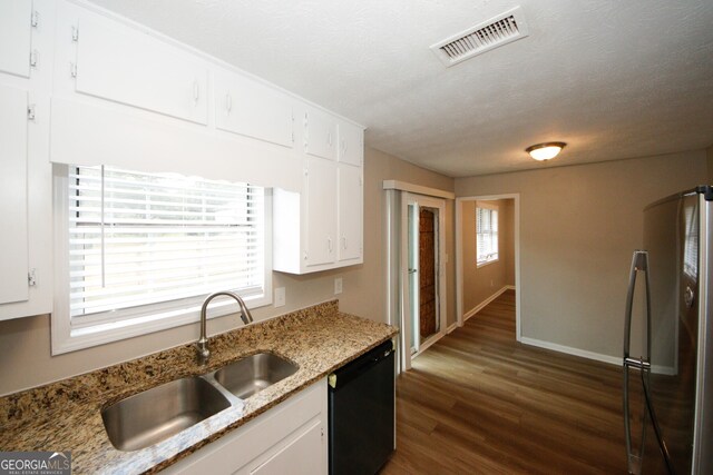 kitchen featuring black dishwasher, dark hardwood / wood-style floors, sink, white cabinetry, and stainless steel refrigerator