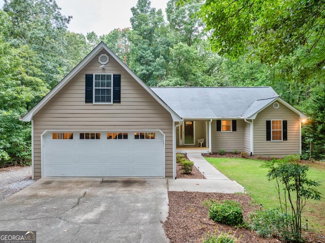 view of front of house featuring a garage and a front yard