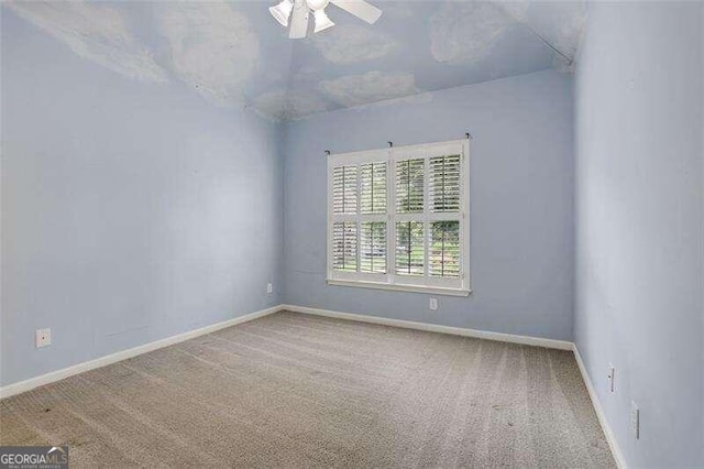 unfurnished room featuring carpet flooring, a ceiling fan, and baseboards