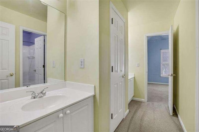 bathroom with vanity and baseboards