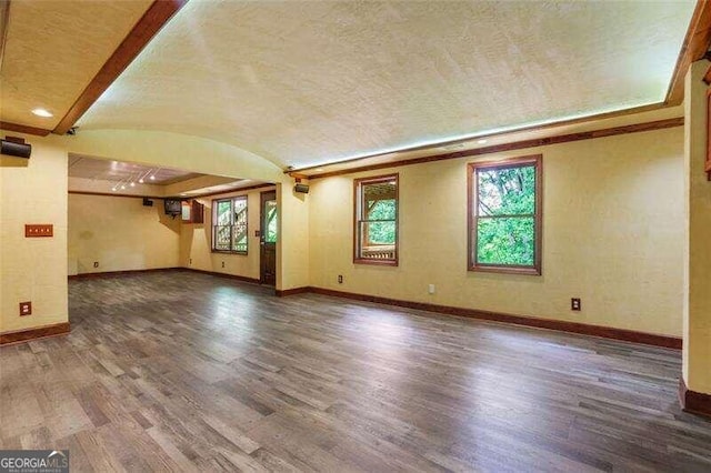 unfurnished living room featuring baseboards and wood finished floors