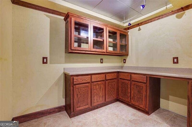 kitchen with glass insert cabinets and light countertops