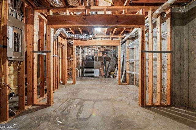 unfinished basement featuring electric panel