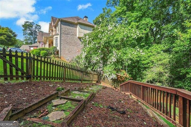 view of yard with a garden and a fenced backyard