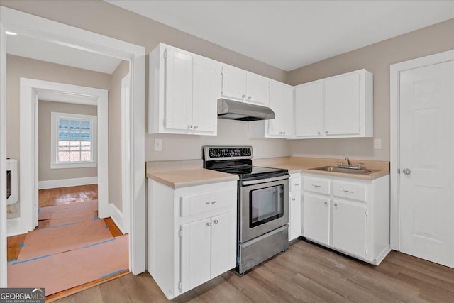 kitchen featuring white cabinetry, sink, electric range, and light hardwood / wood-style flooring