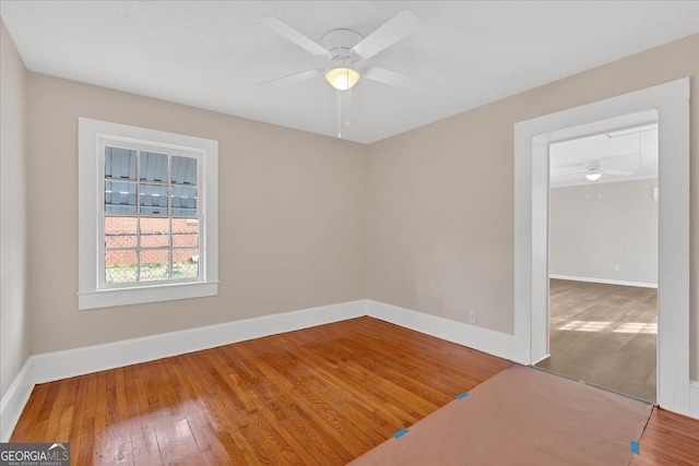 unfurnished room with ceiling fan and hardwood / wood-style floors