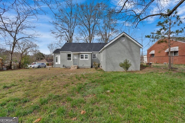 back of house with a lawn