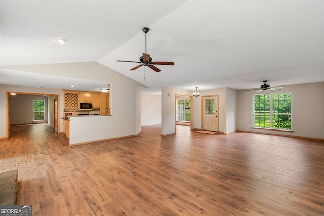 unfurnished living room featuring vaulted ceiling, ceiling fan, and light hardwood / wood-style floors