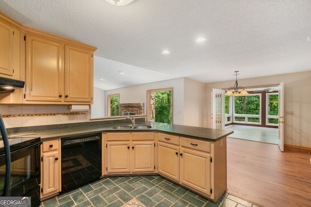 kitchen featuring black appliances, kitchen peninsula, sink, dark wood-type flooring, and vaulted ceiling