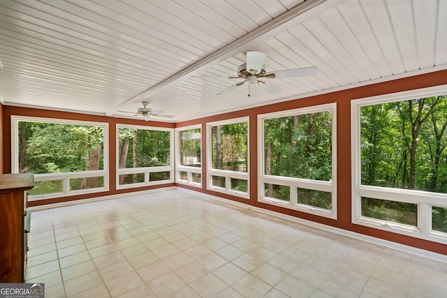 unfurnished sunroom with a wealth of natural light and ceiling fan