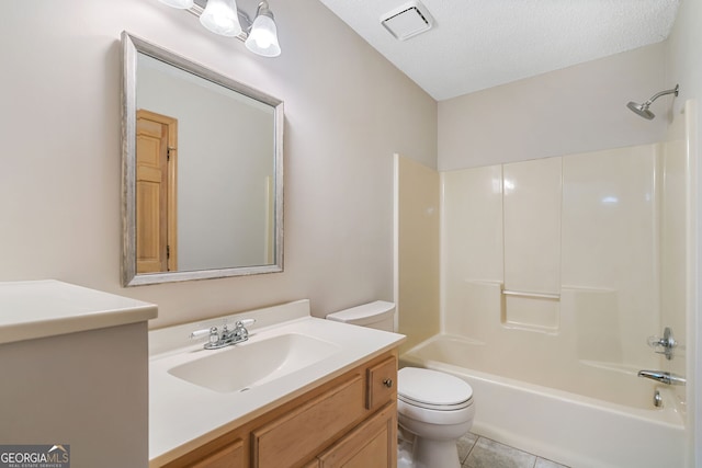 full bathroom featuring tile patterned floors, toilet, bathing tub / shower combination, vanity, and a textured ceiling