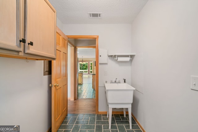 bathroom with hardwood / wood-style floors and a textured ceiling