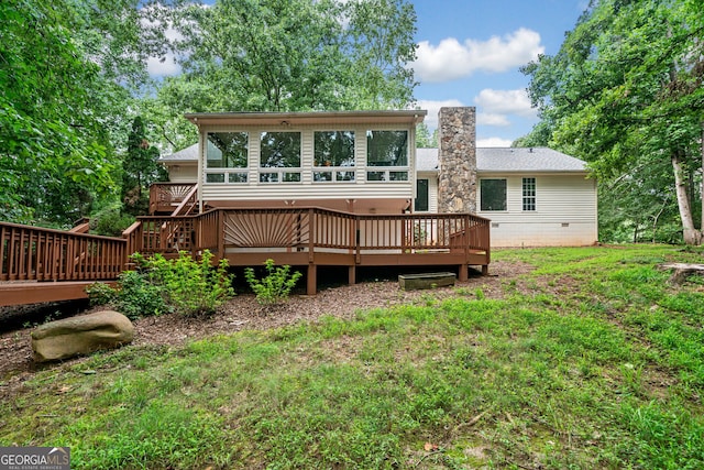 back of house featuring a yard and a deck