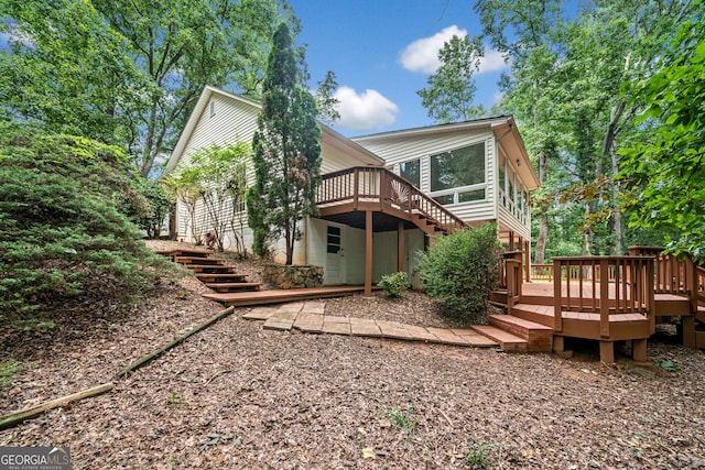 back of property featuring a wooden deck