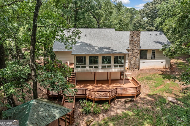 back of house with a wooden deck