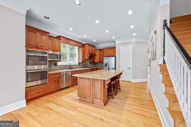 unfurnished dining area with ceiling fan with notable chandelier, light hardwood / wood-style floors, crown molding, and decorative columns