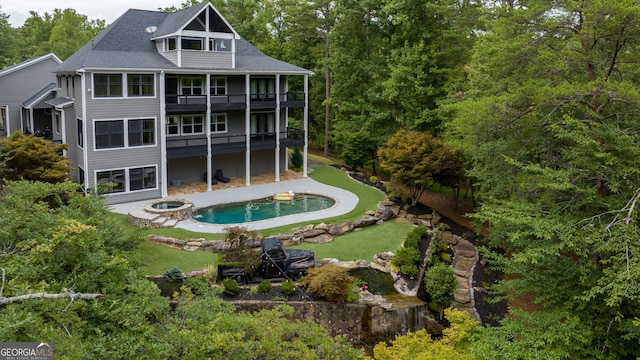 rear view of house with a balcony and a patio area