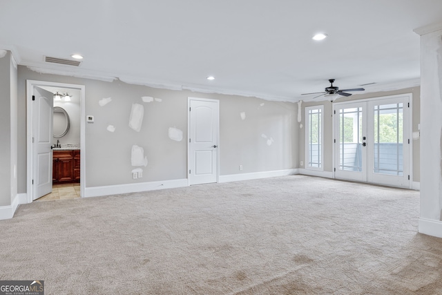 carpeted bedroom featuring ceiling fan, crown molding, and a tray ceiling