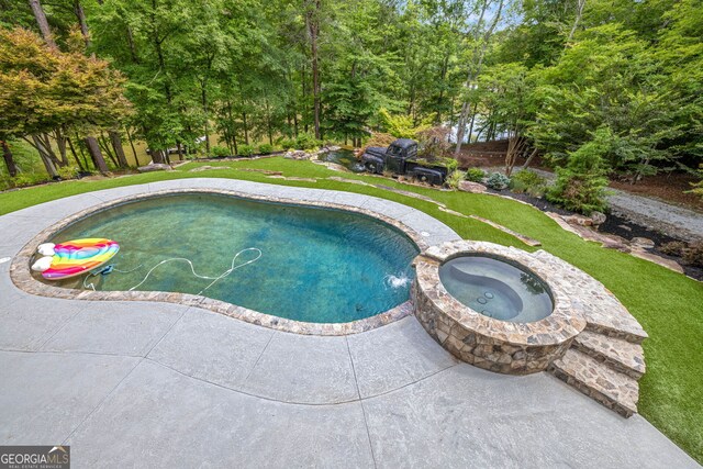 view of swimming pool featuring a yard, an in ground hot tub, and a patio