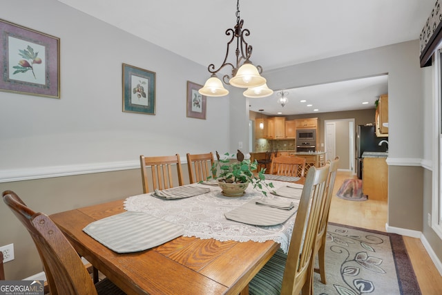 dining space with an inviting chandelier and hardwood / wood-style floors