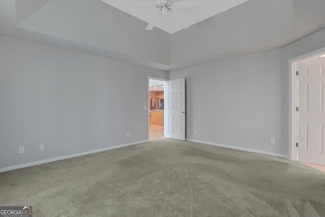 unfurnished room with a towering ceiling, light colored carpet, and ceiling fan