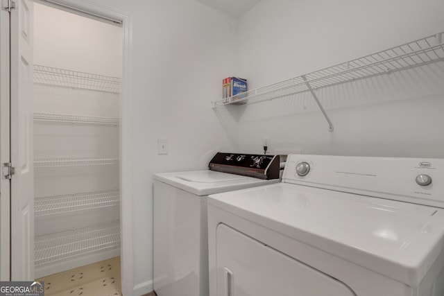 washroom with washer and dryer and light tile patterned floors