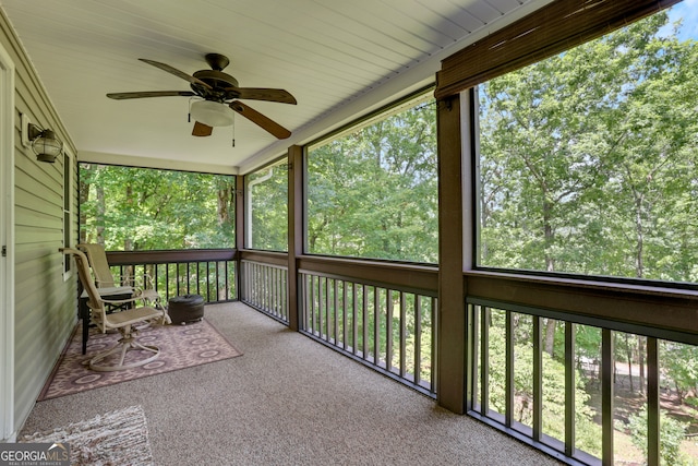 unfurnished sunroom with ceiling fan and a wealth of natural light