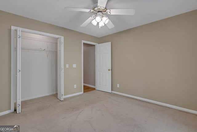 unfurnished bedroom featuring light colored carpet, a closet, and ceiling fan