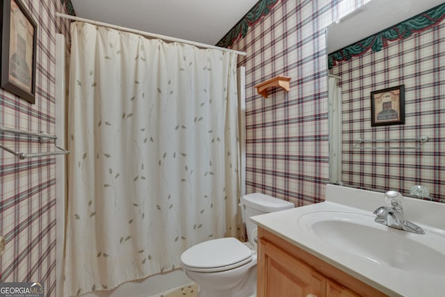 bathroom featuring toilet and vanity