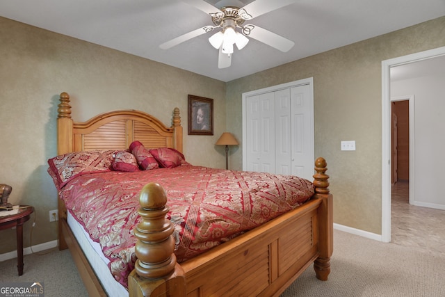 bedroom with light carpet, ceiling fan, and a closet