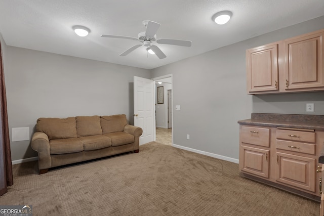 carpeted living room featuring ceiling fan