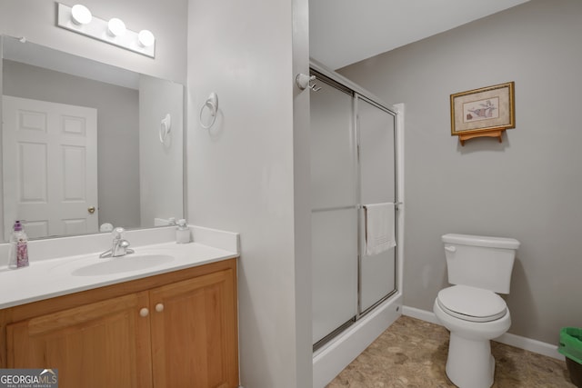 bathroom with tile patterned floors, toilet, vanity, and an enclosed shower