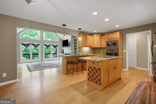 kitchen with light hardwood / wood-style flooring, tasteful backsplash, and stainless steel appliances