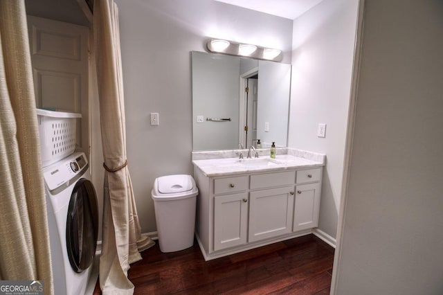 bathroom featuring washer / clothes dryer, vanity, wood-type flooring, and toilet