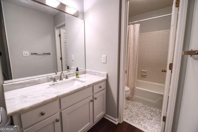 full bathroom with shower / bathtub combination with curtain, hardwood / wood-style flooring, vanity, and toilet