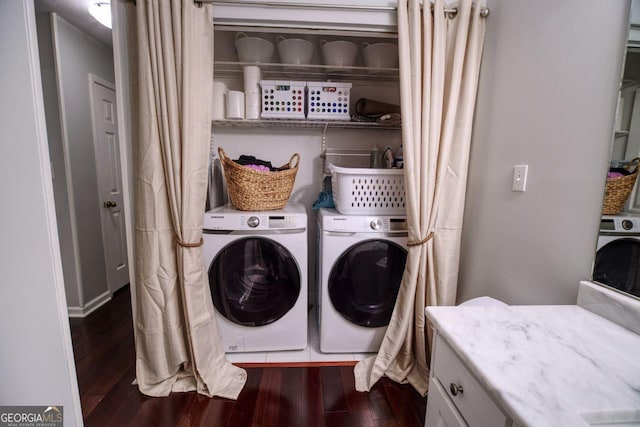 laundry room with washing machine and dryer and dark wood-type flooring