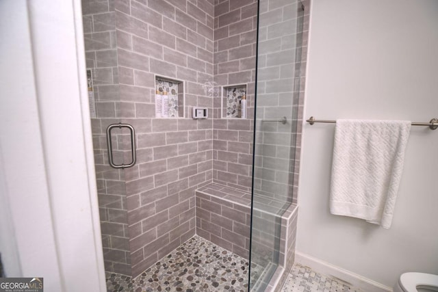 bathroom with toilet and walk in shower