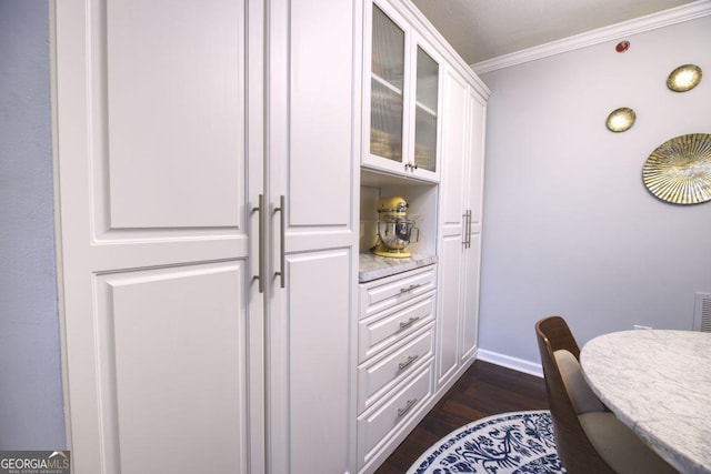 interior space featuring crown molding and dark hardwood / wood-style flooring