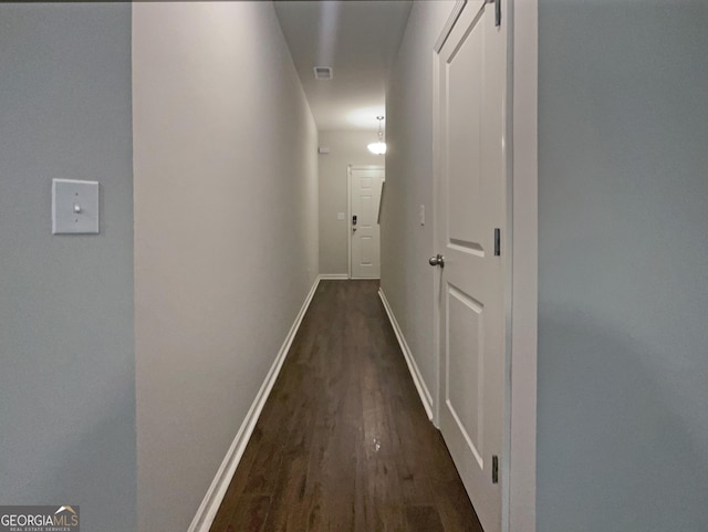 corridor featuring dark hardwood / wood-style floors