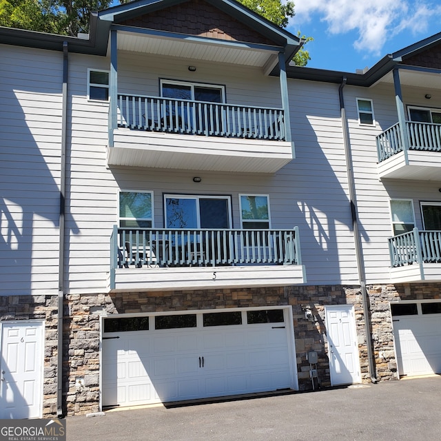 view of front of home featuring a balcony and a garage