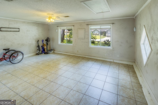 spare room featuring ceiling fan, crown molding, and a textured ceiling