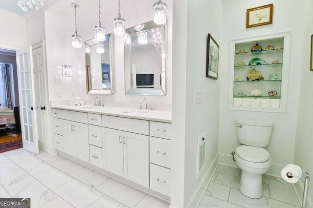 bathroom with toilet, double vanity, ornamental molding, and tile patterned floors