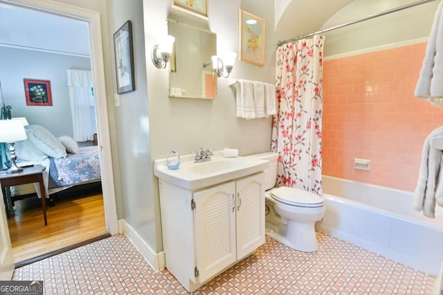 bathroom with baseboards, toilet, tile patterned floors, shower / bath combo with shower curtain, and vanity